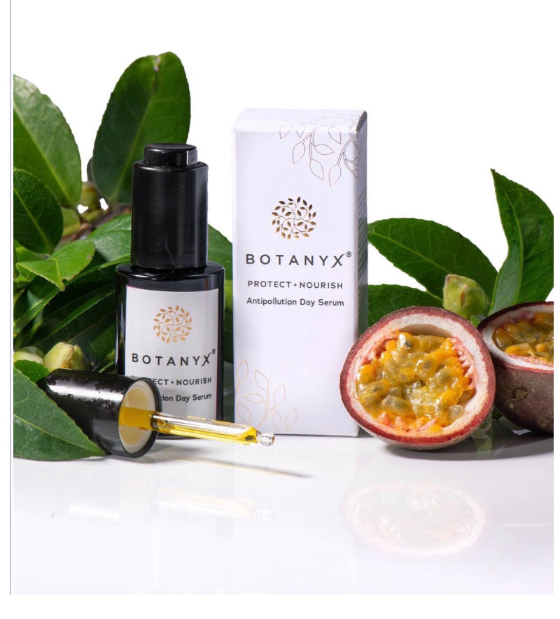 Botanyx skincare products with leaves and a passion fruit on a white background